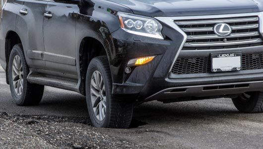 How can potholes damage your vehicle and tires?